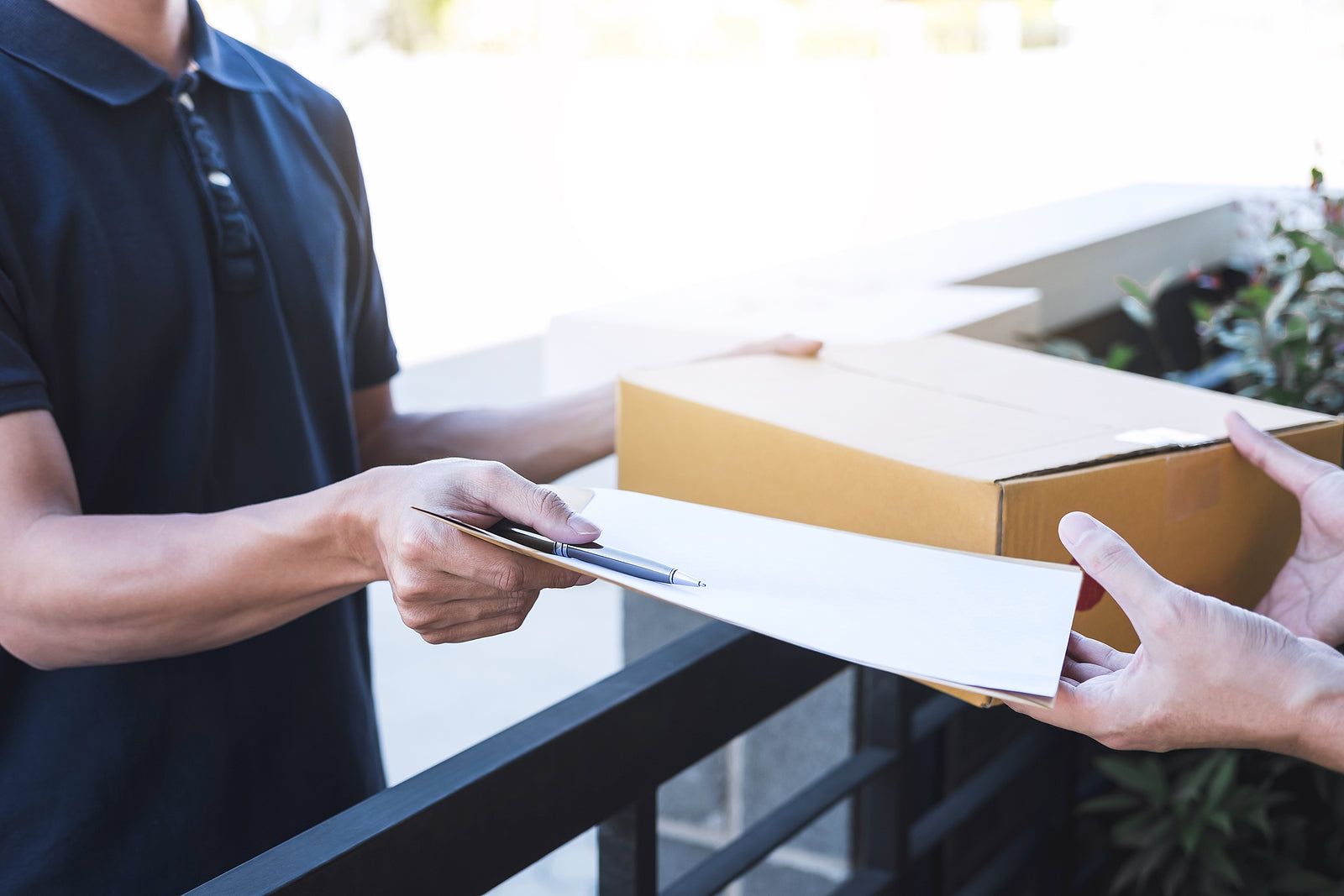 printed shipping boxes - mail man giving parcel box